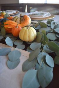 Thankgsiving tablescape with eucalyptus leaves, eucalyptus and pumpkin thanksgiving centerpiece, thanksgiving pumpkin table centerpiece