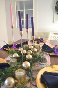 A festive tablescape using advent colors, pink and purple table decorations. Advent decorations, place settings, and centerpiece ideas