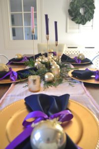 A festive tablescape using advent colors, pink and purple table decorations. Advent decorations, place settings, and centerpiece ideas